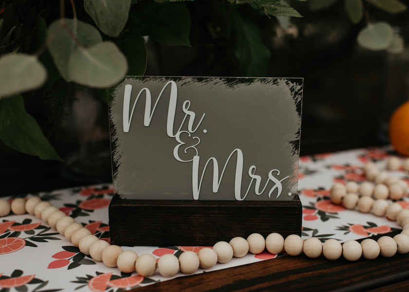 Mr. and Mrs. sign on table with orange print table runner