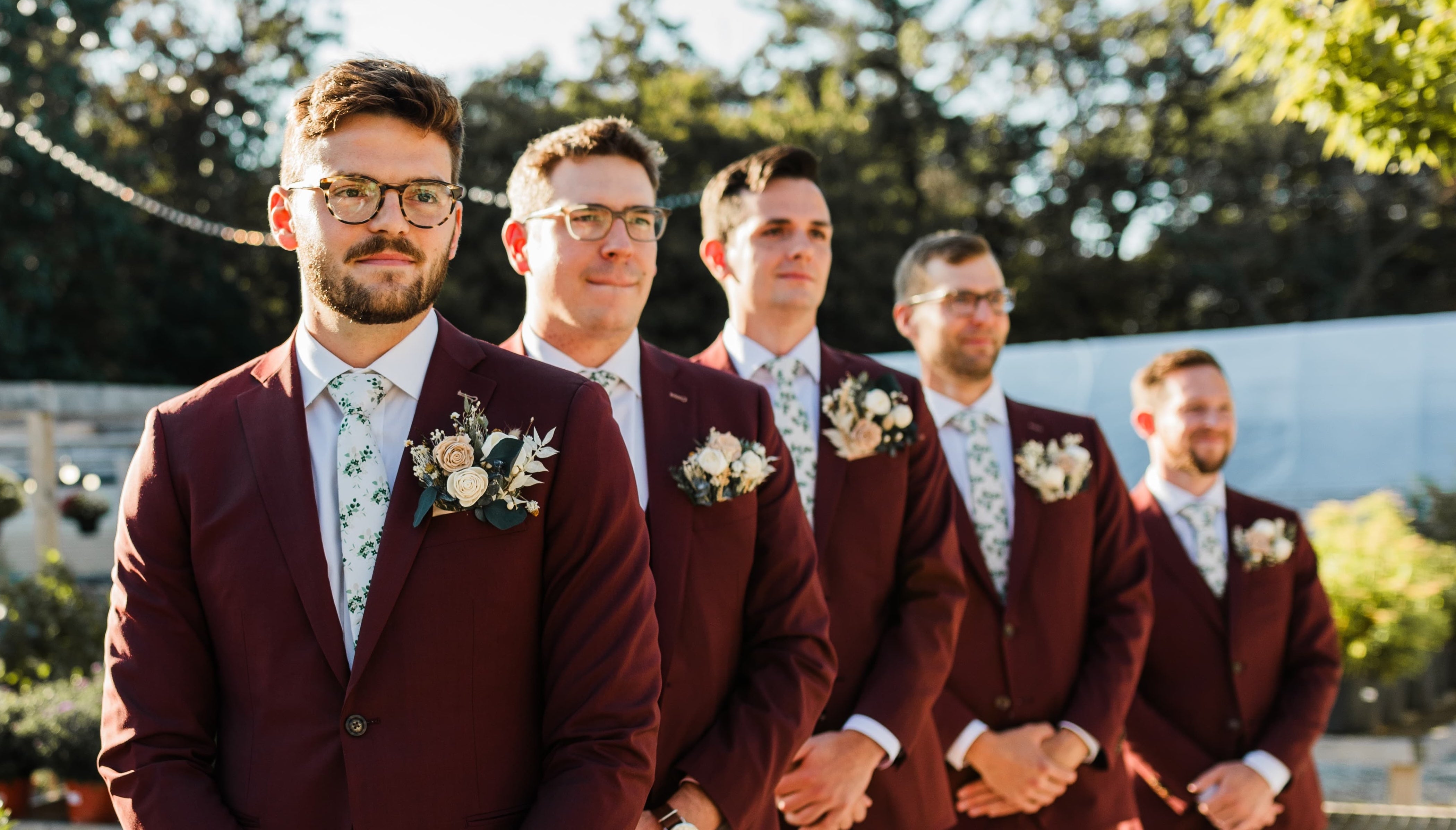 groomsmen wearing ties in a line at wedding