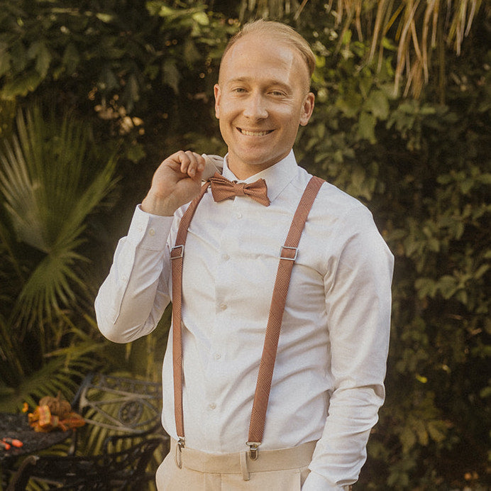 man wearing matching bow tie and suspenders