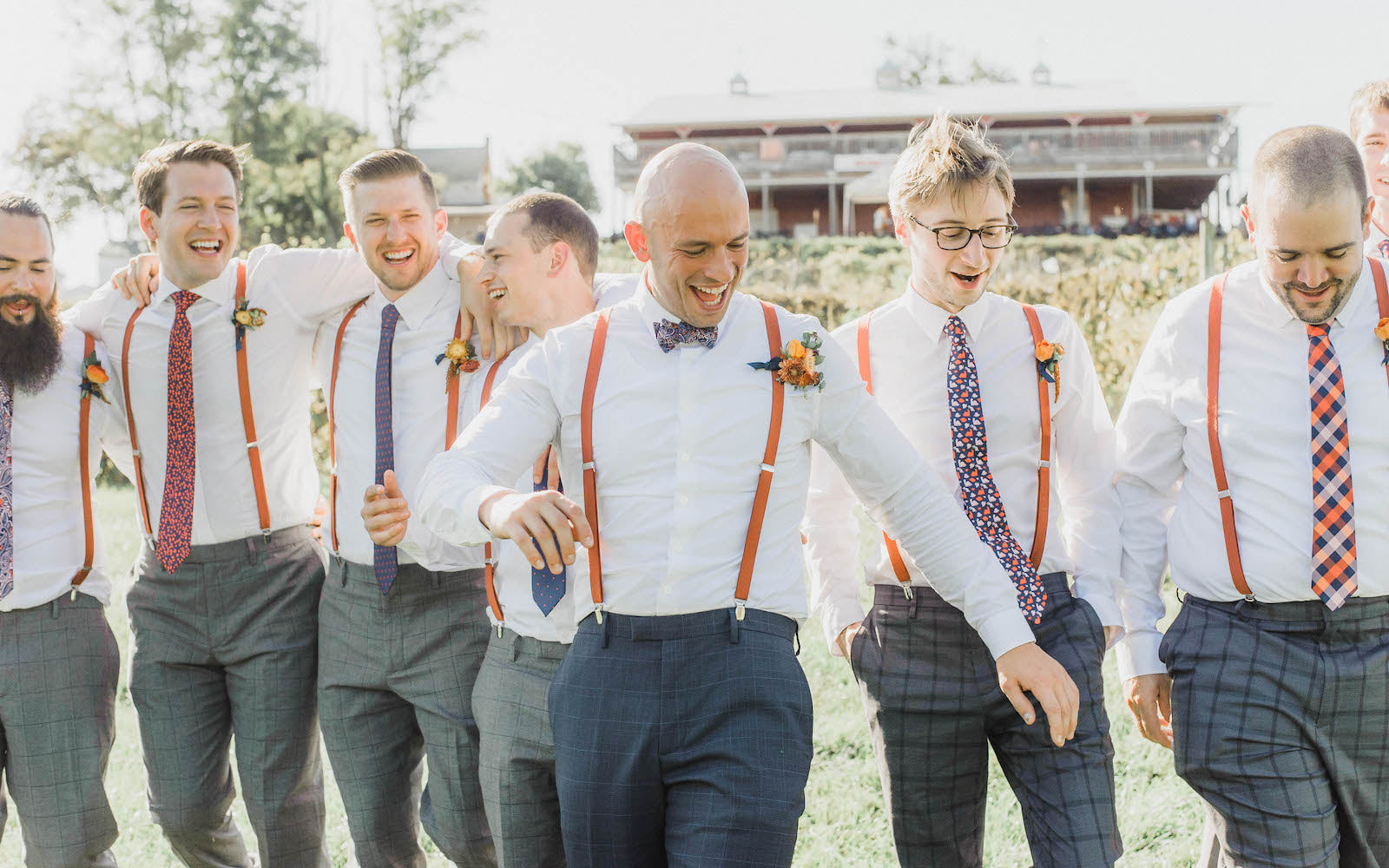 groom and groomsmen wearing different ties, bow ties and suspenders