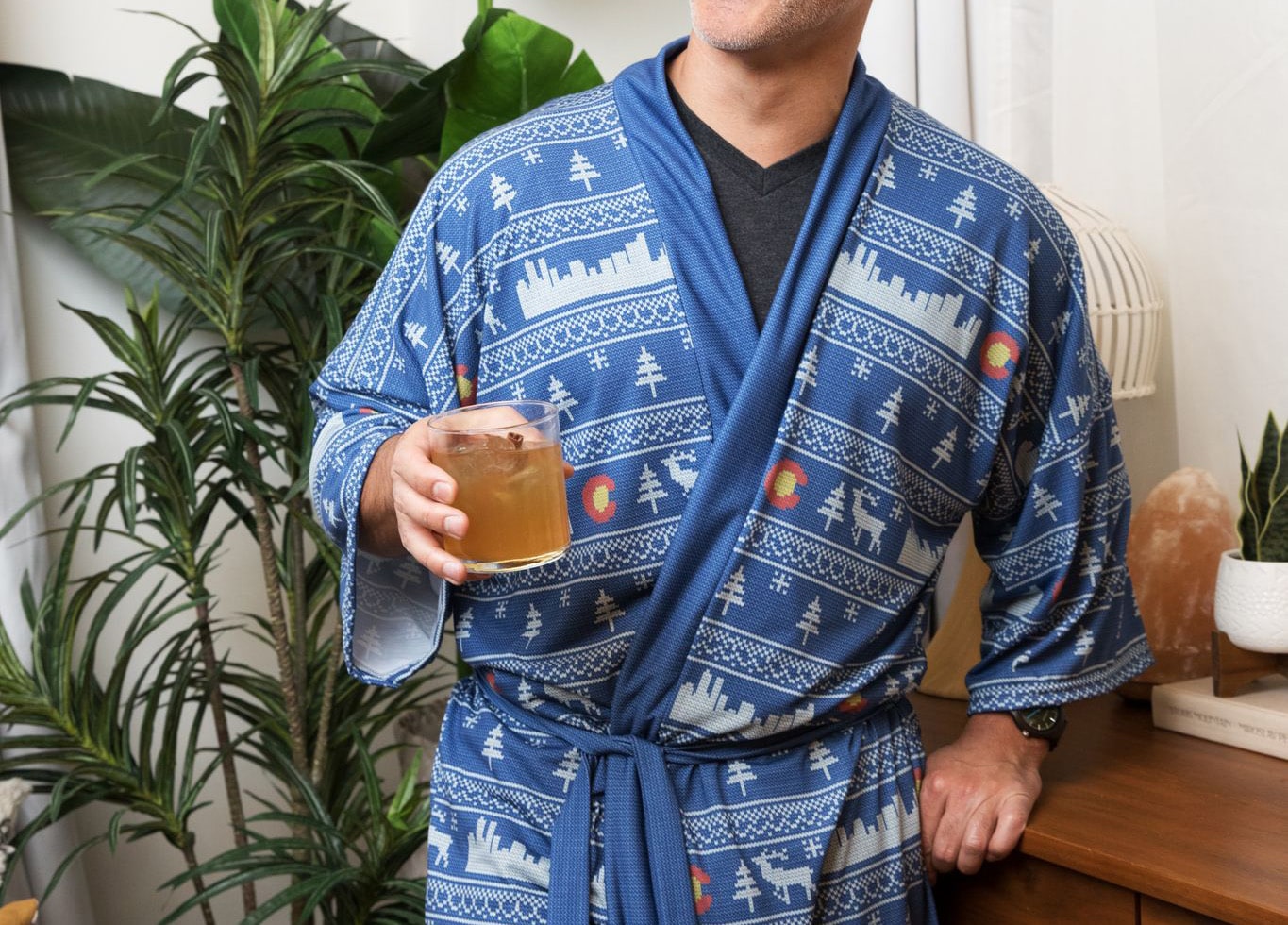Man drinking whiskey wearing colorado themed printed robe